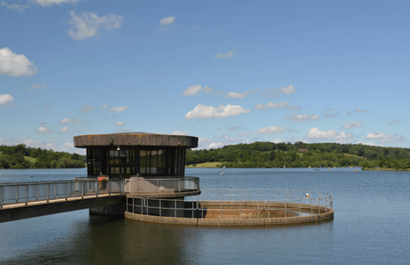 Water treatment facility structure and reservoir infrastructure representing investment and technology adoption in the UK water sector.
